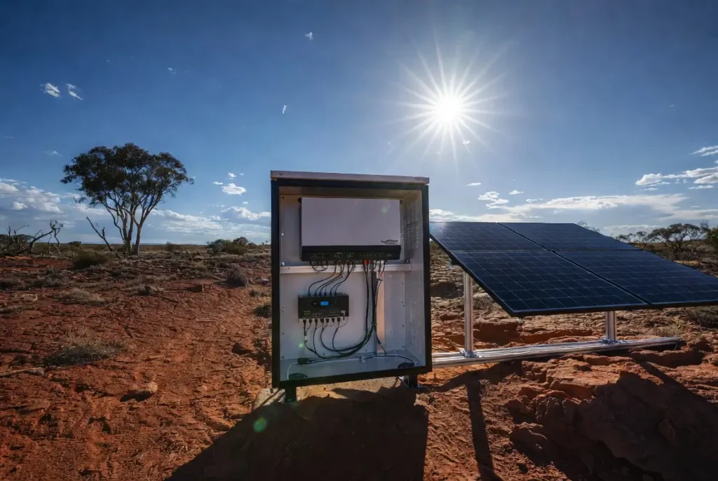 A professional 4K photo of a Victron EasySolar-II mounted in a dust-proof cabinet in the Australian red desert with high-efficiency solar panels.